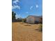 View of the backyard with a pea gravel ground cover and minimal landscaping at 7812 Heather St, New Port Richey, FL 34653