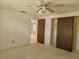 Bedroom with a ceiling fan, closet with sliding doors, and doorway to another room at 7812 Heather St, New Port Richey, FL 34653