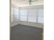 Enclosed porch with carpeted floors and windows offering natural light at 7812 Heather St, New Port Richey, FL 34653