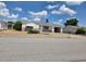 Single-story home featuring an attached garage, awning, and tidy landscaping at 7812 Heather St, New Port Richey, FL 34653