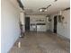 Functional garage space with laundry area, storage, and access door at 7812 Heather St, New Port Richey, FL 34653
