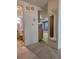 Hallway leading to a bathroom and kitchen, offering views of the home's interior at 7812 Heather St, New Port Richey, FL 34653