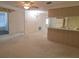 Spacious living and dining area with kitchen, carpet, and access to patio at 7812 Heather St, New Port Richey, FL 34653
