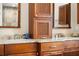 Bathroom featuring double vanity with granite countertop and custom cabinetry at 826 Christina Cir, Oldsmar, FL 34677