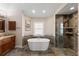 Bright bathroom featuring soaking tub with window, stylish tilework, and a glass enclosed shower at 826 Christina Cir, Oldsmar, FL 34677