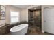 Bathroom featuring freestanding tub, shower, and natural light from a window at 826 Christina Cir, Oldsmar, FL 34677