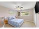 Comfortable bedroom with a ceiling fan, cozy carpet, and a serene window view at 826 Christina Cir, Oldsmar, FL 34677