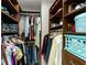 Walk-in closet with dark wood shelving and hanging rods provides ample storage space at 826 Christina Cir, Oldsmar, FL 34677