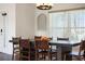 Formal dining room featuring a modern light fixture, seating for six, and large window at 826 Christina Cir, Oldsmar, FL 34677