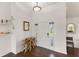 Bright entryway featuring a white door, stylish decorations, and dark wood flooring at 826 Christina Cir, Oldsmar, FL 34677