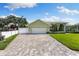 Charming exterior view of home with a three-car garage, well-maintained lawn, and inviting curb appeal at 826 Christina Cir, Oldsmar, FL 34677