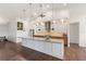 Bright and airy kitchen boasts granite countertops, mosaic backsplash, and large kitchen island at 826 Christina Cir, Oldsmar, FL 34677