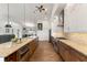 Spacious kitchen featuring a large island, granite countertops, stainless steel appliances, and wood floors at 826 Christina Cir, Oldsmar, FL 34677