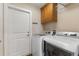 Laundry room with a washer, dryer, storage cabinet, and access door at 826 Christina Cir, Oldsmar, FL 34677