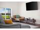 Living room features a comfortable couch, modern TV, and slider doors leading to an outdoor view at 826 Christina Cir, Oldsmar, FL 34677