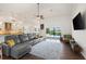 Open concept living room with modern furniture, sliding glass doors to the pool area, and view of the water at 826 Christina Cir, Oldsmar, FL 34677