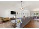 Bright living room featuring a leather sofa, modern ceiling fan, and dark wood flooring at 826 Christina Cir, Oldsmar, FL 34677