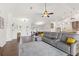 Open concept living room featuring a large sofa with views of the kitchen and dining area at 826 Christina Cir, Oldsmar, FL 34677