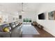 Living room with large sofa, modern TV, and slider doors leading to an outdoor pool with water view at 826 Christina Cir, Oldsmar, FL 34677
