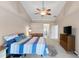 Spacious bedroom has access to the ensuite bathroom and features vaulted ceiling and backyard views at 826 Christina Cir, Oldsmar, FL 34677