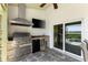 Outdoor kitchen featuring a stainless steel grill, sink, and mini refrigerator for easy entertaining at 826 Christina Cir, Oldsmar, FL 34677