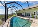 This outdoor oasis features a screened-in pool with water views at 826 Christina Cir, Oldsmar, FL 34677