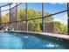 Sparkling water feature from a screened pool with surrounding landscaping and a clear blue sky at 826 Christina Cir, Oldsmar, FL 34677