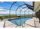The screened in pool offers stunning water views at 826 Christina Cir, Oldsmar, FL 34677