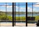 An expansive view of the backyard pool and lake from inside a sunroom with floor to ceiling windows at 826 Christina Cir, Oldsmar, FL 34677