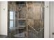Bathroom shower featuring unique tilework, grab bar, and glass enclosure at 826 Christina Cir, Oldsmar, FL 34677