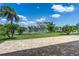 Serene backyard featuring a brick-paved patio overlooking a picturesque pond and lush landscaping at 8518 Tidal Bay Ln, Tampa, FL 33635