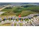 Aerial view of houses in a neighborhood highlighting community layout, greenery, and proximity to natural surroundings at 8607 Bower Bass Cir, Wesley Chapel, FL 33545