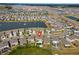 Stunning aerial view of a residential area with a lake, showcasing the homes' proximity to waterfront and community amenities at 8607 Bower Bass Cir, Wesley Chapel, FL 33545