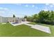 Backyard with artificial turf and a stone outdoor kitchen and bar at 8607 Bower Bass Cir, Wesley Chapel, FL 33545