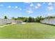 A view of backyard with artificial turf and a stone outdoor kitchen and bar at 8607 Bower Bass Cir, Wesley Chapel, FL 33545