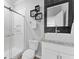 Modern bathroom with a glass-enclosed shower, vessel sink, and stylish black and white accents at 8607 Bower Bass Cir, Wesley Chapel, FL 33545