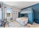 Charming bedroom featuring a blue accent wall and bunk beds at 8607 Bower Bass Cir, Wesley Chapel, FL 33545