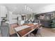 Elegant dining area with stylish lighting, a spacious table, and open access to the kitchen and living space at 8607 Bower Bass Cir, Wesley Chapel, FL 33545