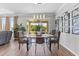 Comfortable dining space with a modern table setting, ample natural light, and backyard view at 8607 Bower Bass Cir, Wesley Chapel, FL 33545