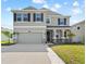 Stunning two-story home featuring a two-car garage, landscaped front yard, and welcoming front porch at 8607 Bower Bass Cir, Wesley Chapel, FL 33545