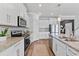 Bright, modern kitchen with white cabinets, granite countertops, and stainless steel appliances at 8607 Bower Bass Cir, Wesley Chapel, FL 33545