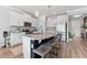 A modern kitchen featuring white cabinets, stainless steel appliances, and a granite countertop island with seating at 8607 Bower Bass Cir, Wesley Chapel, FL 33545