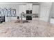 A close up of a kitchen island with granite countertops and a stainless steel sink and faucet at 8607 Bower Bass Cir, Wesley Chapel, FL 33545