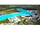 Community lagoon featuring clear blue waters, beach areas, recreational amenities, and nearby residences at 8607 Bower Bass Cir, Wesley Chapel, FL 33545