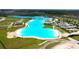 High-angle view of a large lagoon features clear blue waters and recreational beach amenities at 8607 Bower Bass Cir, Wesley Chapel, FL 33545