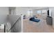 Upstairs loft area with carpet flooring, a futon, and ample natural light from the windows at 8607 Bower Bass Cir, Wesley Chapel, FL 33545