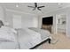 Spacious main bedroom featuring a ceiling fan, TV, and ensuite bathroom access at 8607 Bower Bass Cir, Wesley Chapel, FL 33545