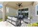Covered patio with a ceiling fan and stylish outdoor furniture at 8607 Bower Bass Cir, Wesley Chapel, FL 33545