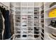 Organized shoe closet with custom shelving and ample storage for shoes and accessories at 8607 Bower Bass Cir, Wesley Chapel, FL 33545