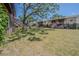 Backyard view of multi-story townhomes, wooden staircases, patios, and shade trees at 9031 Westchester Cir # 128, Tampa, FL 33604